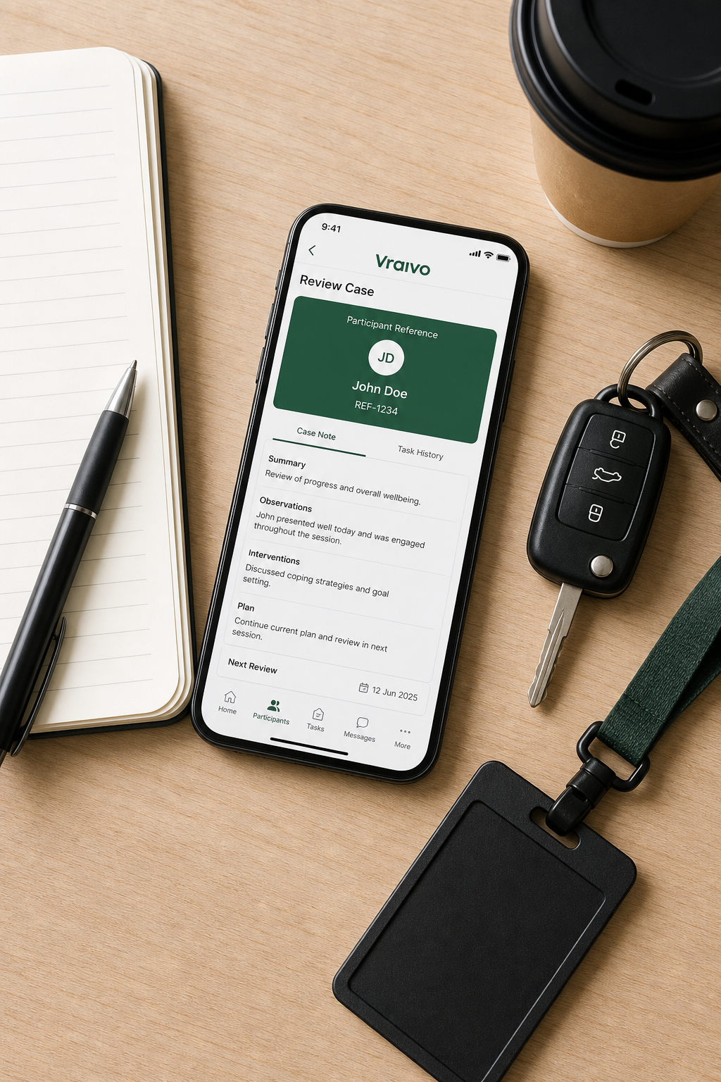 Vraivo app on phone with notebook and keys